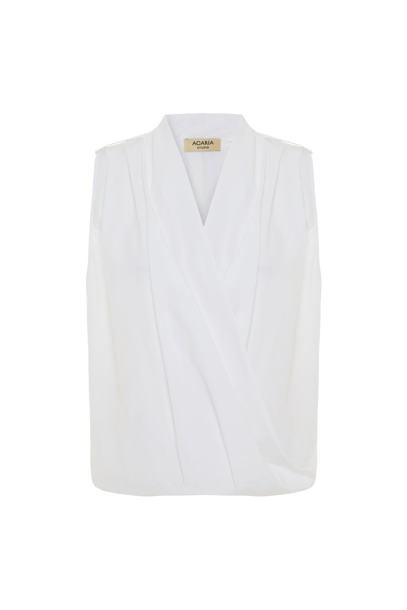 White Dahlia top by Acaria Studio, a stylish women's blouse with elegant design and soft fabric, displayed on a hanger.
