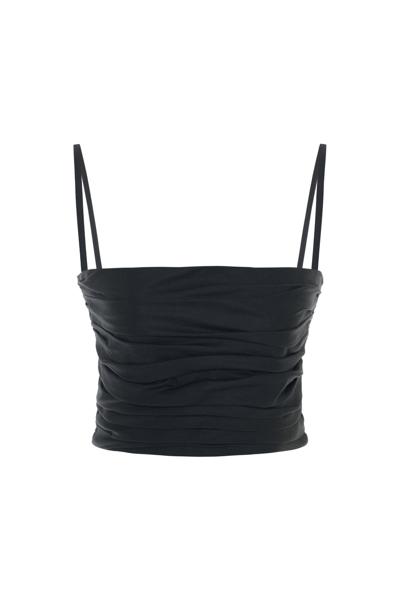 Black Wissy top by Acaria Studio, featuring a stylish design, displayed on a hanger against a neutral background.