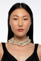 Silvia Gnecchi Marlon Gold Pearly Necklace featuring a delicate chain with lustrous pearls on a white background.