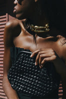 Black leather clutch bag from Adriana Castro's LA POPA LEATHER collection, featuring sleek design and subtle texture.