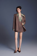 Black Keira Tong minimal fitted mini skirt shown on a model, highlighting a sleek, tailored design and high-waisted fit.