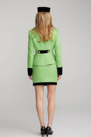 Nana Jacqueline Michelle Green Tweed Mini Skirt shown on a model, featuring a high-waisted design and classic tweed fabric.
