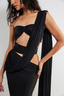 Deme By Gabriella Inga Black Cut-Out Maxi Dress displayed on a hanger with a flowing silhouette and stylish cut-out details.