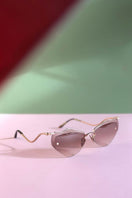 Moy Atelier Lilla Forget Me Not sunglasses with round frames and floral-inspired design, featuring tinted lenses.