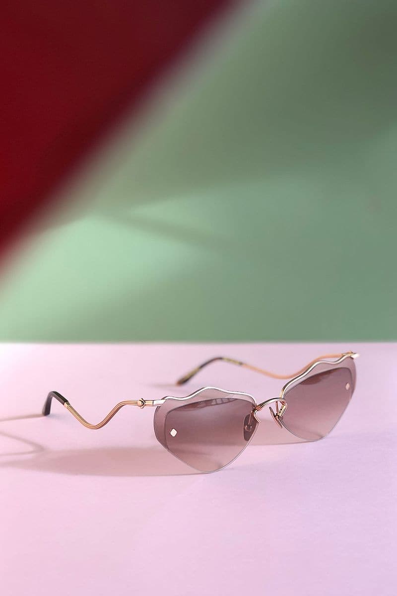 Moy Atelier Lilla Forget Me Not sunglasses with round frames and floral-inspired design, featuring tinted lenses.