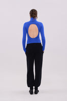 Blue long sleeve top by La Granni featuring a fitted design and soft fabric, shown on a model.