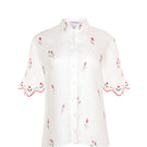 Estefania ivory tulip shirt featuring a flowy fabric and elegant design, displayed flat with detailed collar and sleeves.