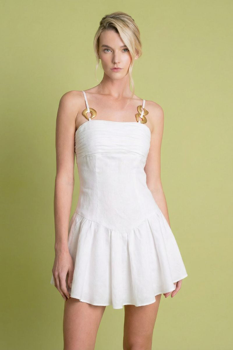 White sunny dress by Laura Escobar, mini dress style with a flowy fabric and stylish design, perfect for summer or casual wear.