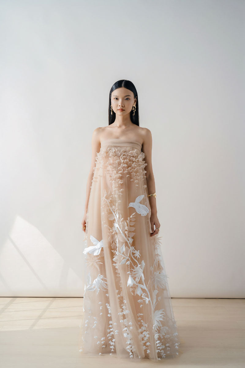 NUDE 3D-floral tulle gown by DOC BAN, elegant maxi dress with intricate floral details and flowing fabric.
