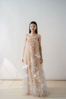 NUDE 3D-floral tulle gown by DOC BAN featuring intricate floral embroidery and flowing tulle fabric for elegant wear