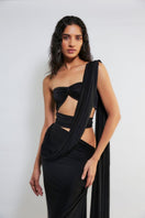 Deme By Gabriella Inga black cut-out maxi dress with stylish side cut-outs and flowing fabric, perfect for elegant occasions.