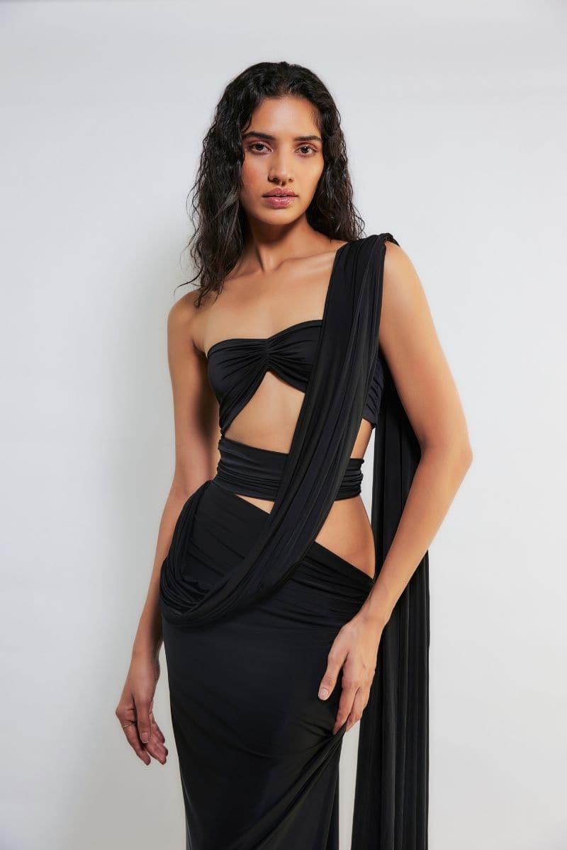 Deme By Gabriella Inga black cut-out maxi dress with stylish side cut-outs and flowing fabric, perfect for elegant occasions.