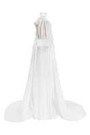 White Glacial Grace gown by Le Thanh Hoa featuring elegant flowing fabric and intricate detailing for formal occasions.