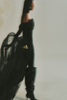 L'SCARLETT form-fitting off-shoulder long-sleeve poly crepe jumpsuit displayed on a model.