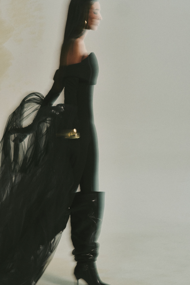 L'SCARLETT form-fitting off-shoulder long-sleeve poly crepe jumpsuit displayed on a model.