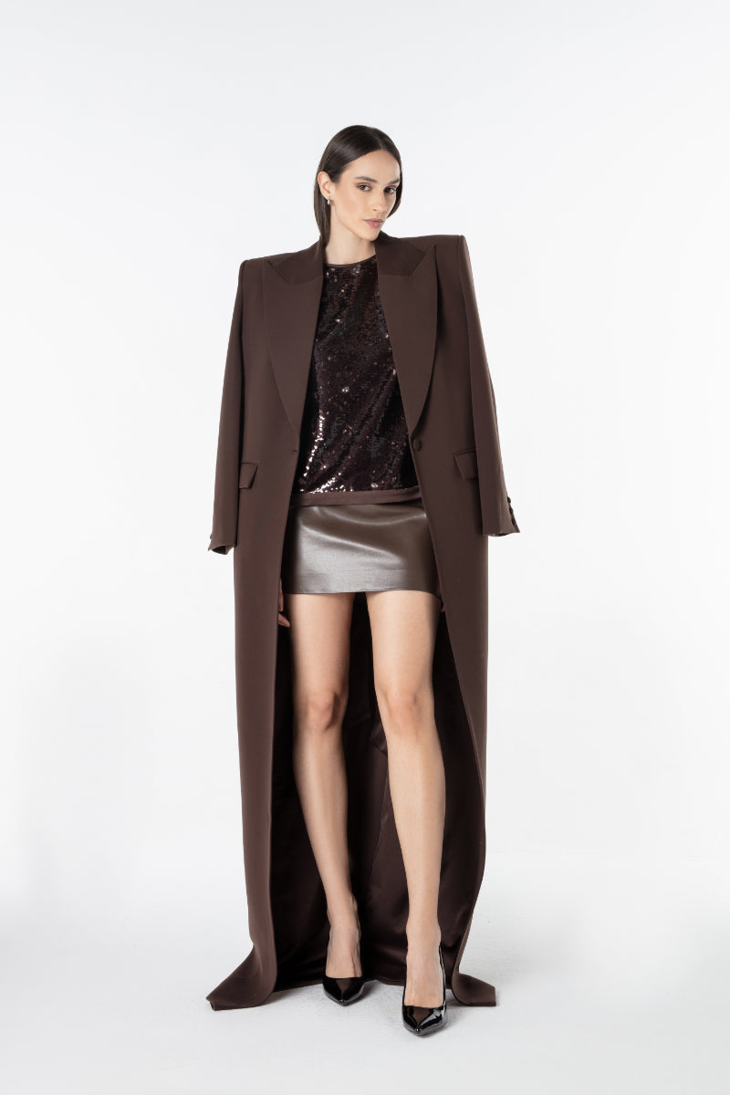 Lili Blanc oversized coat in neutral fabric, shown draped on a hanger with a focus on its relaxed, oversized fit and textured material.