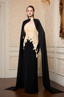 Beige strapless column gown with long cape by I.H.F, shown on a mannequin highlighting elegant, flowing fabric and sophisticated design.