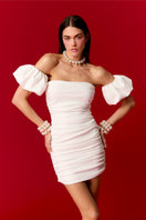 Nur Karaata Bernadette mini dress shown in black fabric with a fitted silhouette and short sleeves, stylish and elegant.