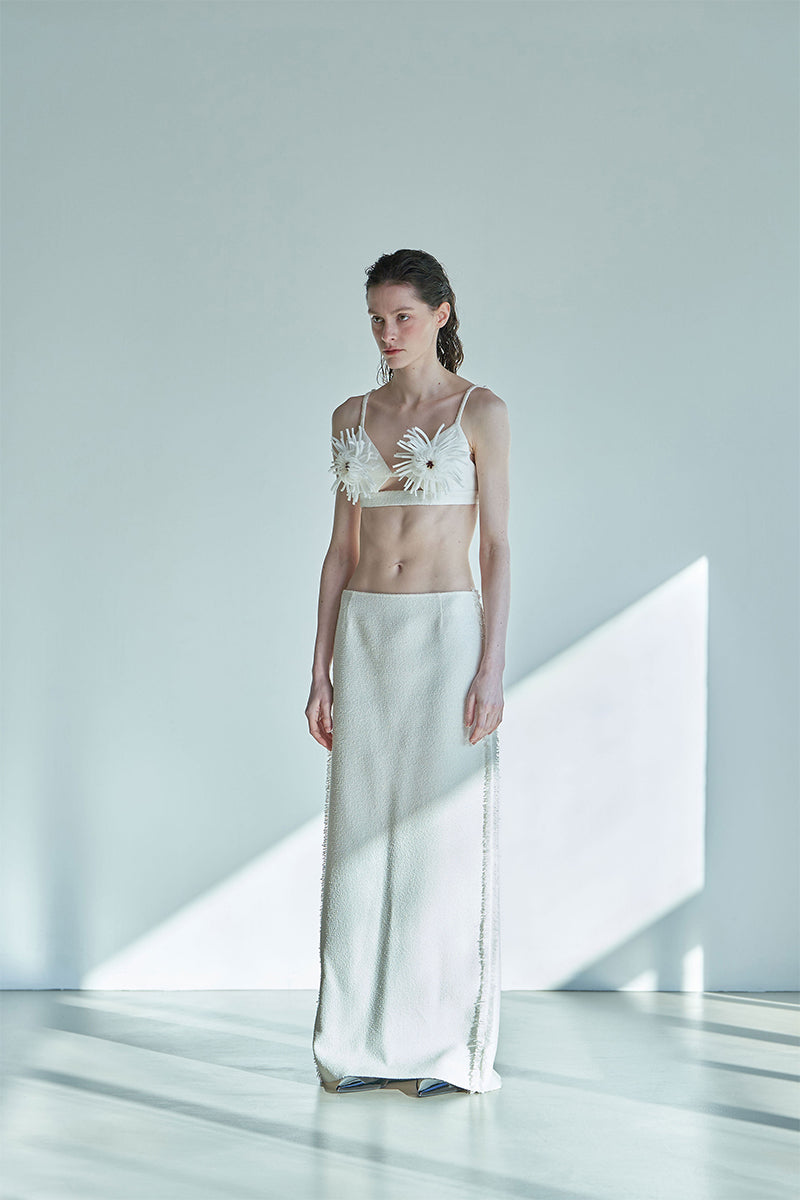 JINSUN ivory Pappus Tweed Maxi Skirt displayed on a model, showcasing its elegant length and textured tweed fabric.