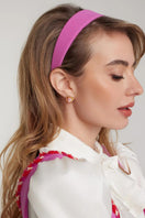 Nana Jacqueline Amber pink and gold heart earrings, delicate jewelry with pink and gold heart-shaped design on a jewelry display