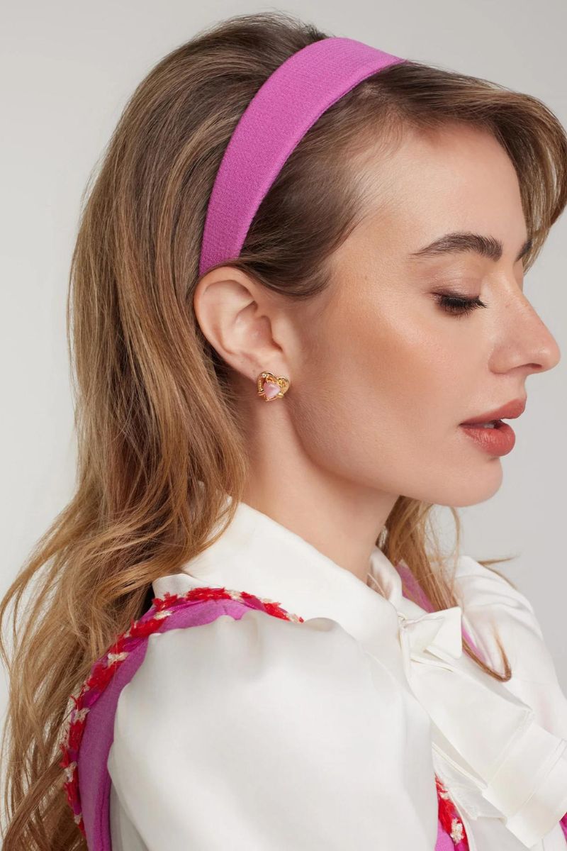 Nana Jacqueline Amber pink and gold heart earrings, delicate jewelry with pink and gold heart-shaped design on a jewelry display