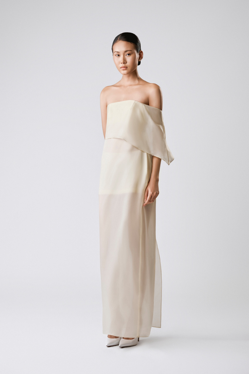 Light beige vanilla drape maxi dress by TONYY featuring flowing fabric and elegant style, perfect for summer events.