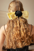 Two Tuscan Rose Bow silk hair clips from Not Just Pajama, featuring elegant pink rose designs and smooth silk fabric.