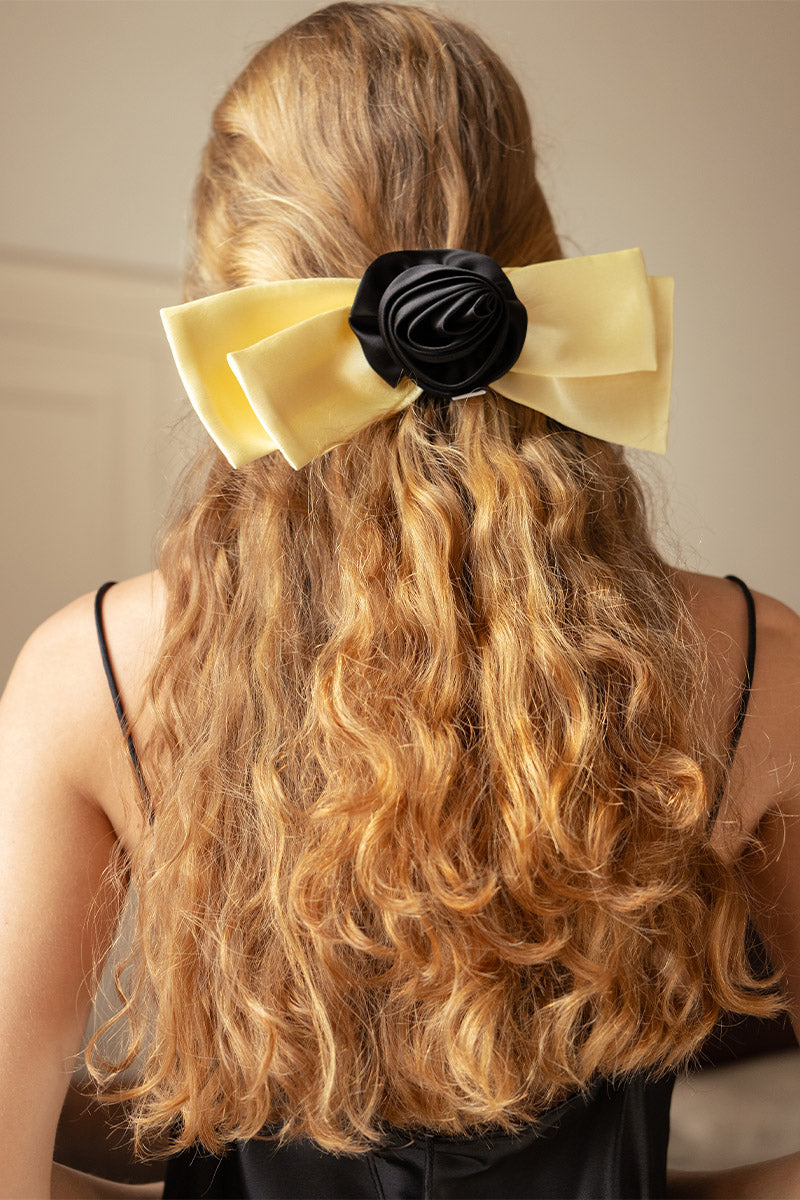 Two Tuscan Rose Bow silk hair clips from Not Just Pajama, featuring elegant pink rose designs and smooth silk fabric.