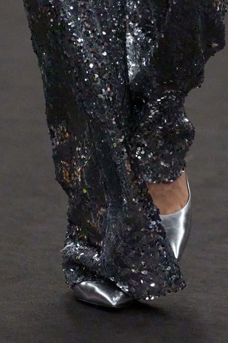 Lili Blanc sequin high-waist trousers showcasing shiny sequined fabric and tailored fit, stylish for evening wear or parties.