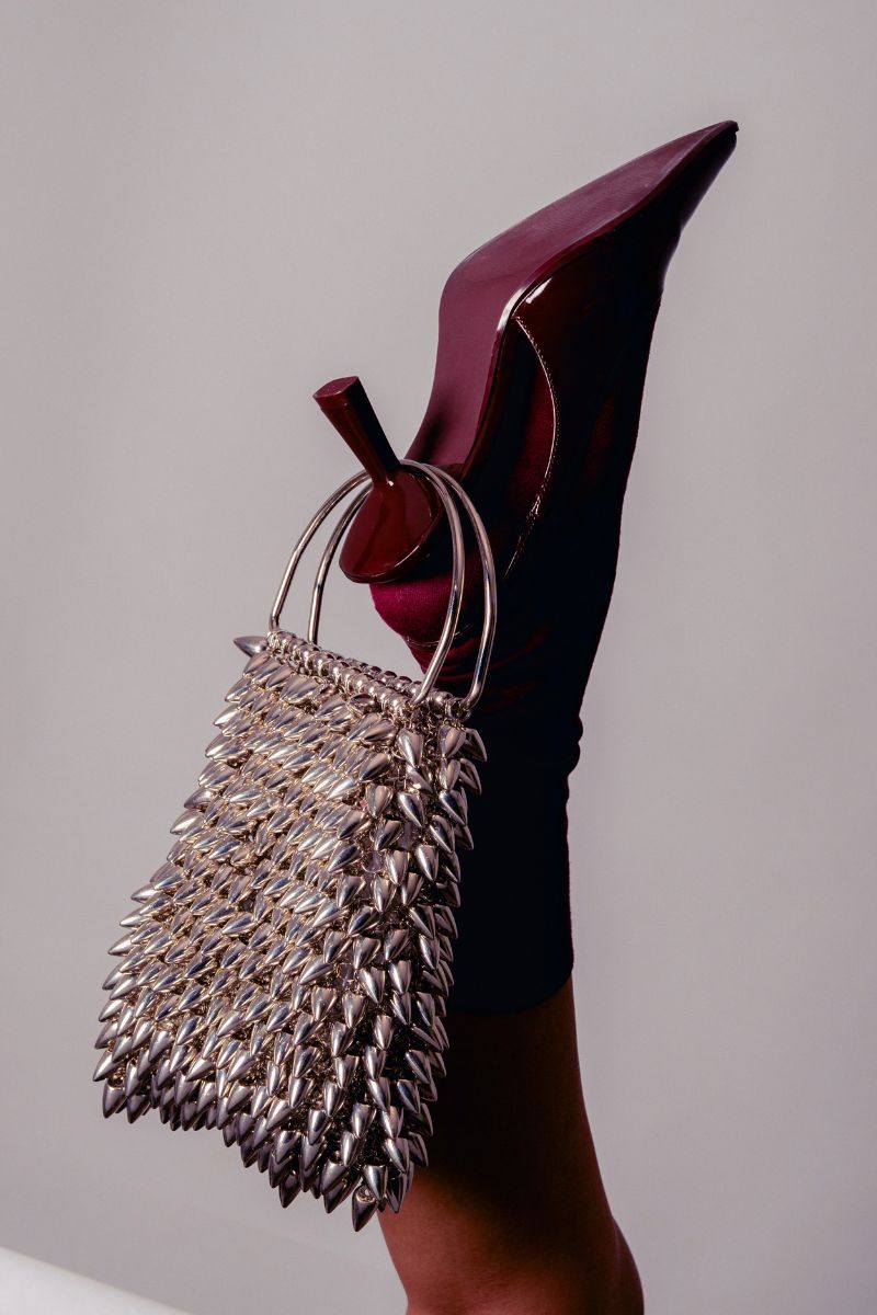 Millanne Tale IONA Silver Top Handle Bag with sleek design, silver finish, and sturdy top handle for elegant carrying.