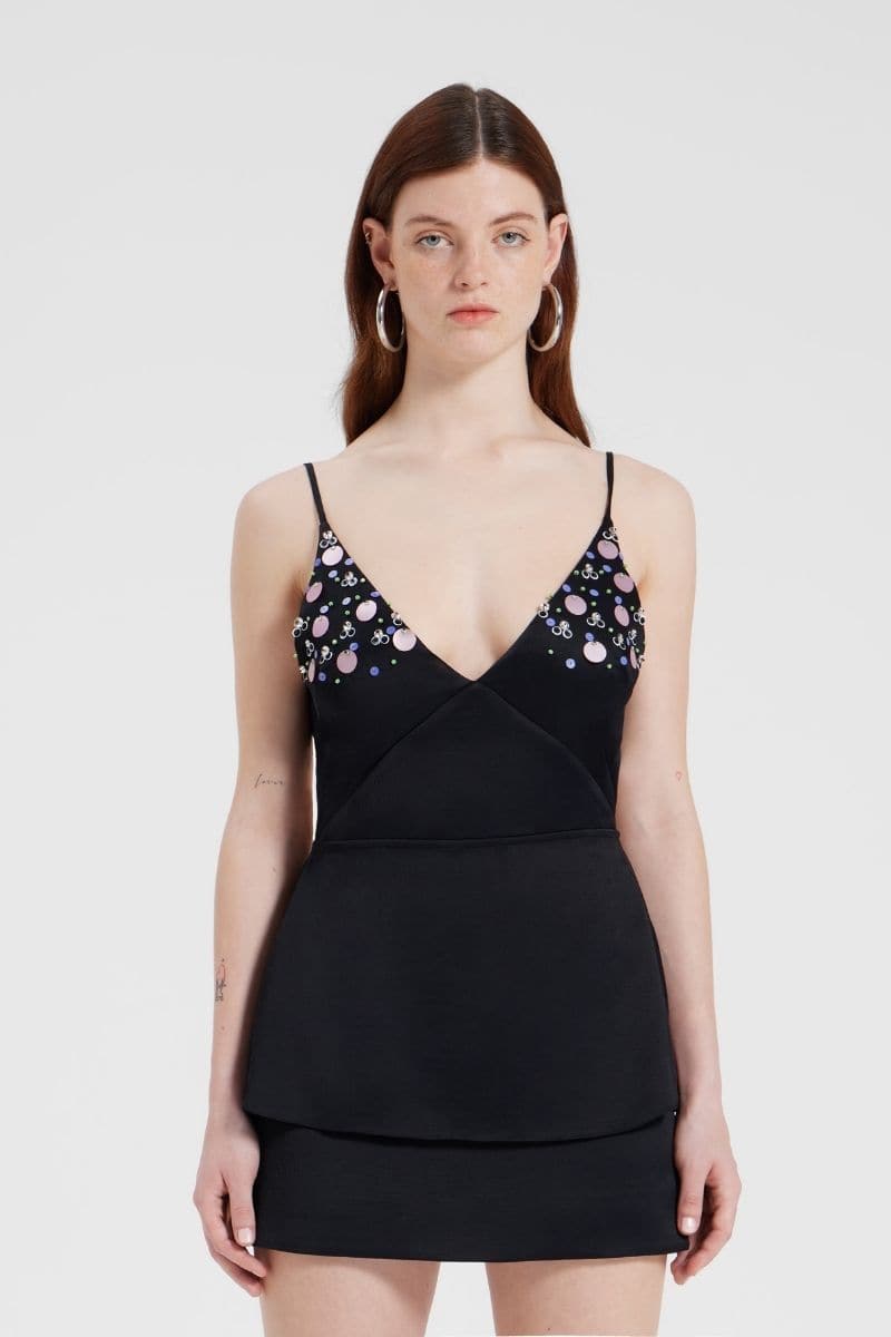 Black embroidered V-neck top by Nara Niro featuring intricate embroidery and a flattering V-neck design.