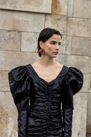 Liya Heartfelt red earrings featuring heart-shaped design, hanging on silver hooks, vibrant and stylish jewelry accessory