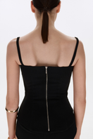 Black matte silk corset top with straps from BALYKINA, featuring a fitted design and smooth fabric.