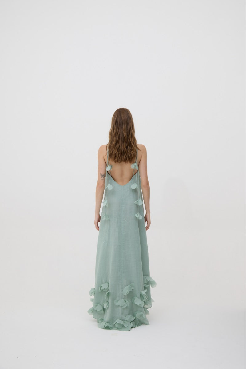 Mint green Kontenta Aurora maxi dress displayed on a hanger, featuring a flowing fabric and elegant design.