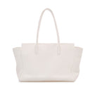 Off-white tote bag by Vikele Studio, shoulder bag with spacious interior and minimalist design, shown in a natural outdoor setting.