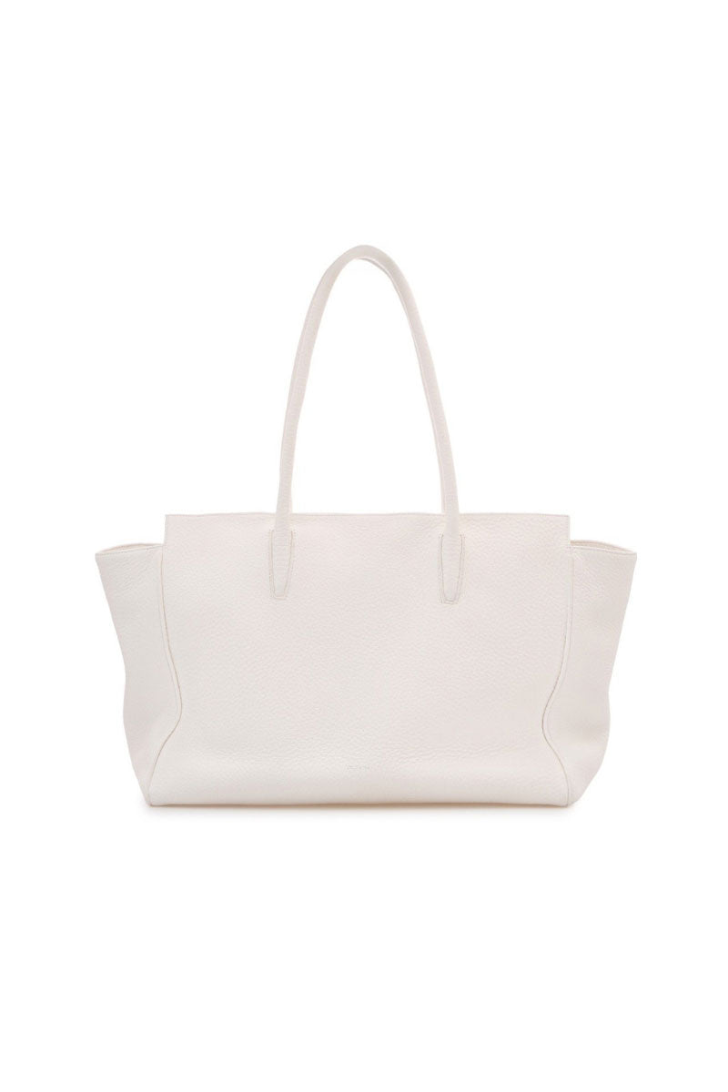 Off-white tote bag by Vikele Studio, shoulder bag with spacious interior and minimalist design, shown in a natural outdoor setting.