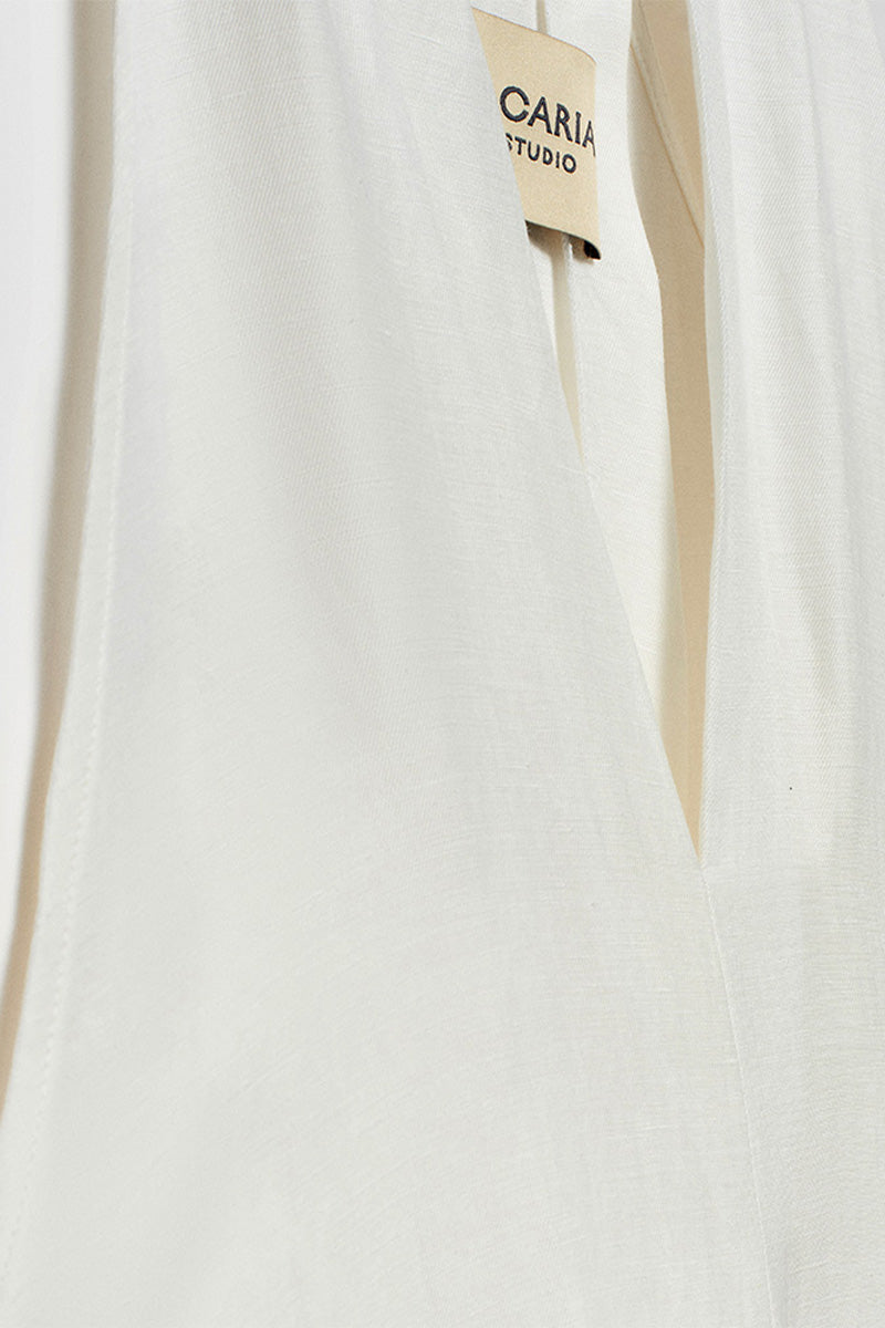 White Acaria Studio La Plage maxi dress with flowy fabric and sleeveless design, perfect for summer beachwear.