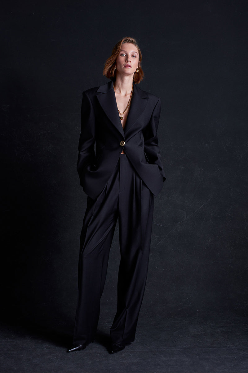 Black Earth Pants by Acaria Studio, featuring a relaxed fit and stylish design, displayed on a model against a neutral background.
