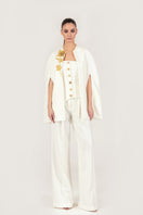 Gold thread embroidered cape from Monika Dimova, elegant jacket with intricate gold embroidery and luxurious fabric details.