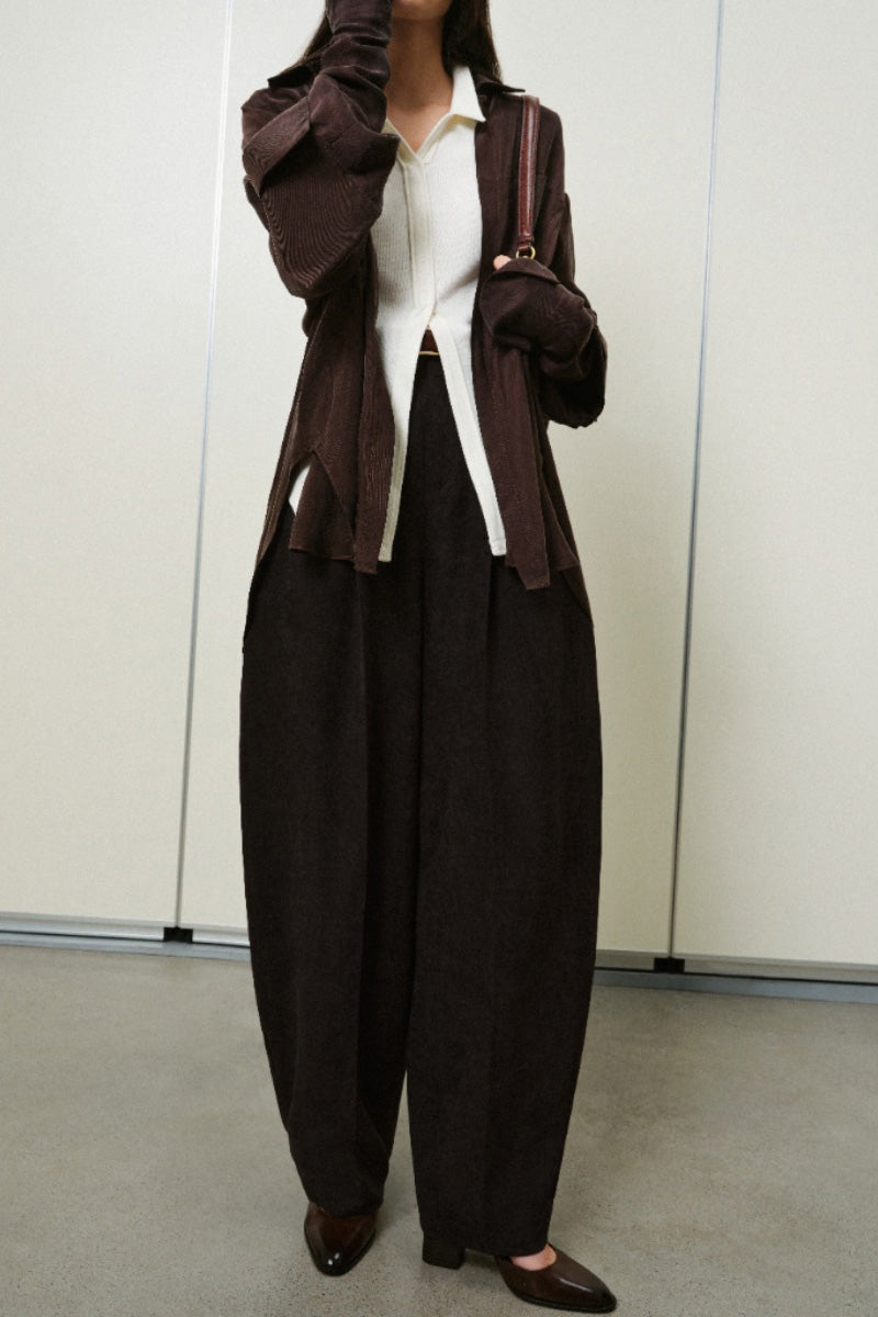 Light blue Lecia balloon trousers with a relaxed fit and elastic waistband, shown on a hanger.