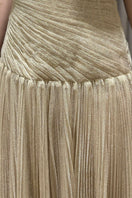 Elegant gold draped gown by Montsand featuring flowing fabric and sophisticated design, perfect for formal occasions.