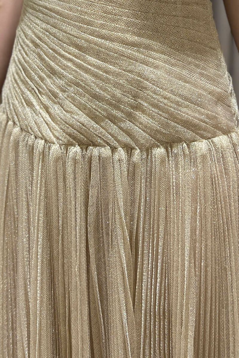 Elegant gold draped gown by Montsand featuring flowing fabric and sophisticated design, perfect for formal occasions.