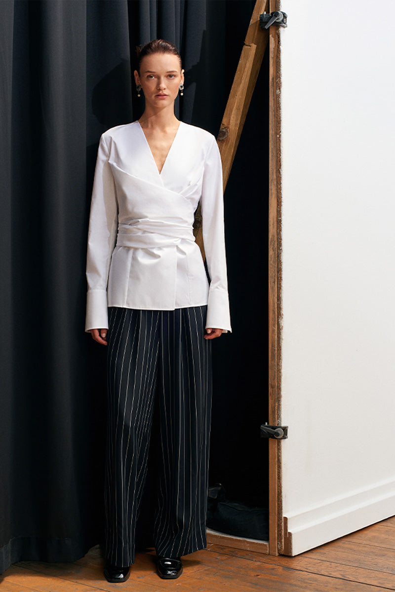Black and white striped harem pants by Acaria Studio with a relaxed fit and elastic waistband, shown on a model.