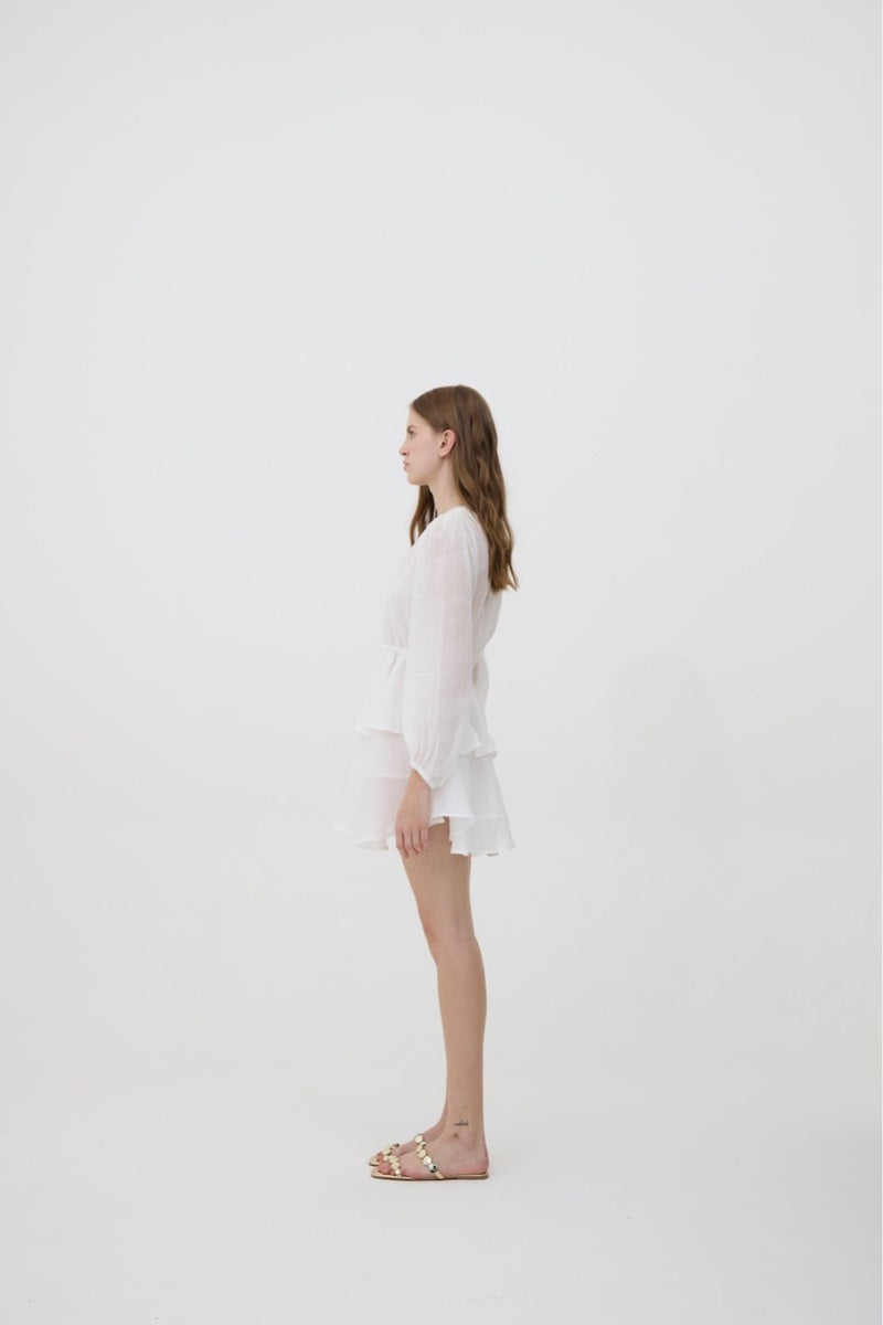 White Sofia mini dress by Kontenta, showcasing a stylish, sleeveless design with a fitted waist and elegant silhouette.