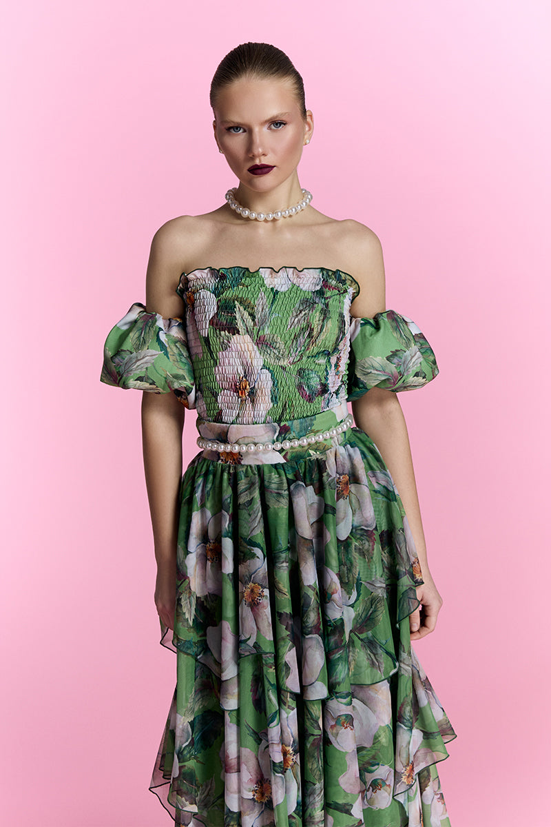 Nur Karaata Provence Poème gown featuring floral embroidery and flowing fabric, displayed on a mannequin in a well-lit room.