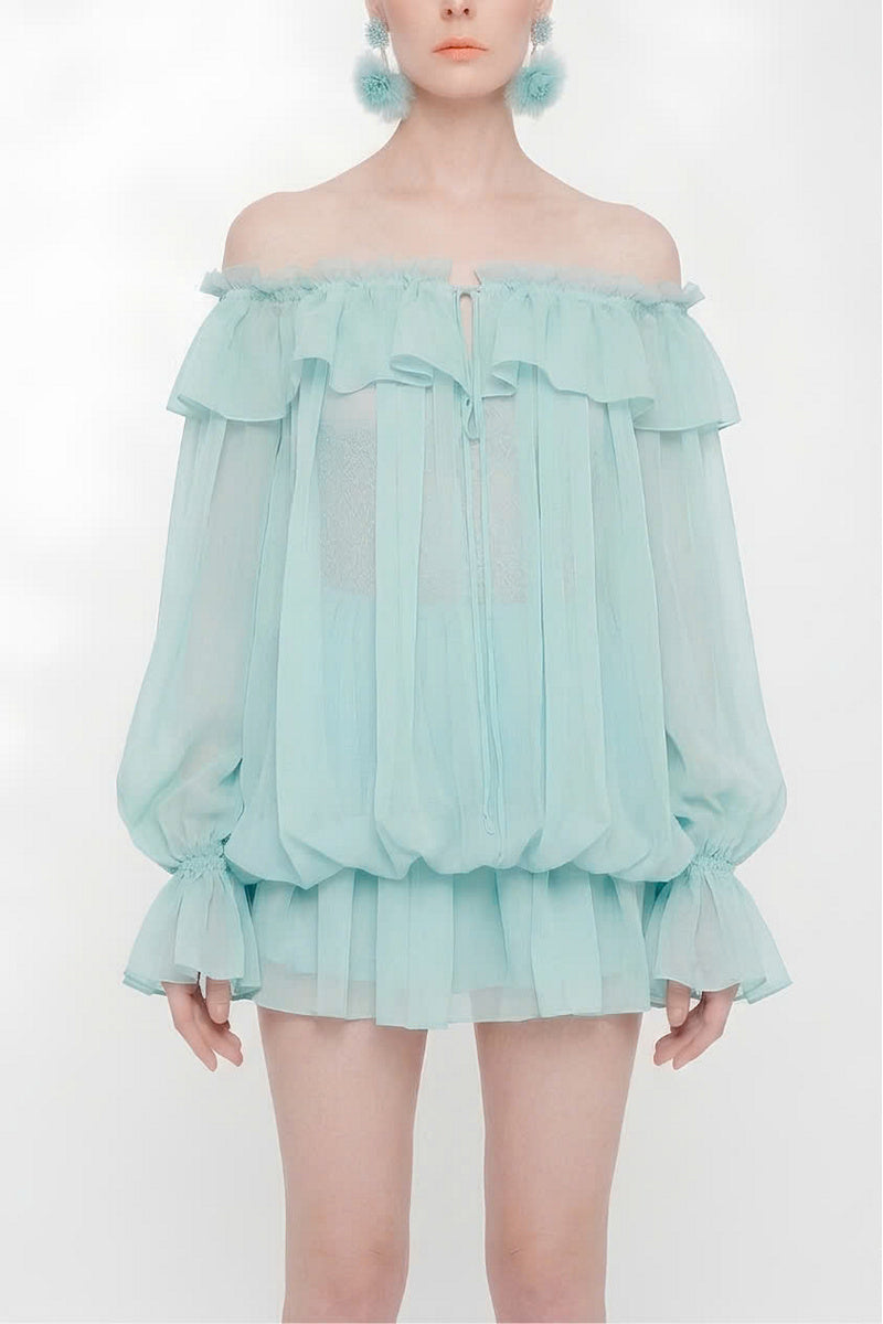 Valenciani off-shoulder mini dress styled as a scarf, featuring vibrant fabric and elegant drape on a mannequin.