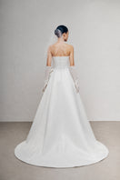 White Plan Lejei maxi dress featuring a flowing fabric and elegant design, perfect for casual or formal occasions.