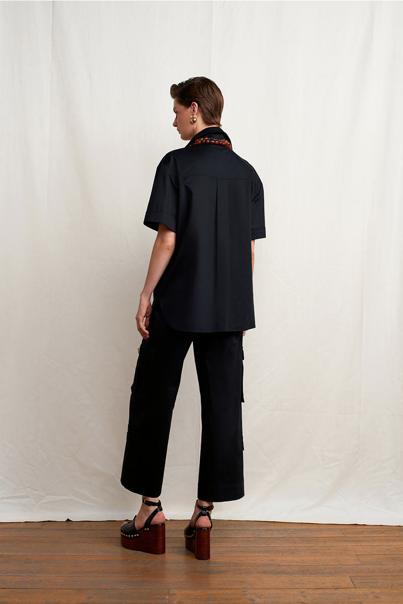 Black Warrior Wide Pants by Acaria Studio displayed on a model, showcasing their relaxed fit and wide-leg design.