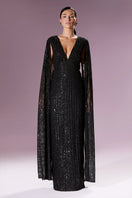 Elegant Nur Karaata Giovanna gown with flowing fabric and intricate details, showcased on a mannequin.