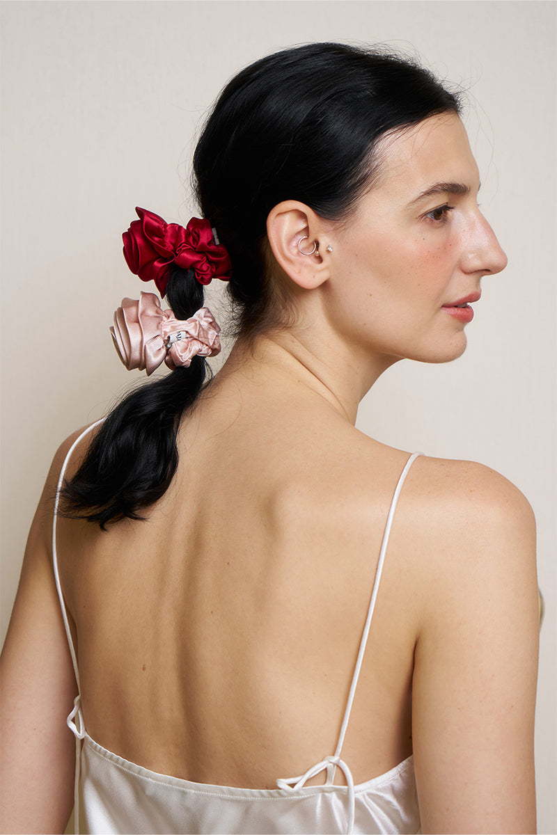 Two Tuscan Rose silk scrunchies from Not Just Pajama, featuring soft, luxurious silk fabric perfect for hair accessories.